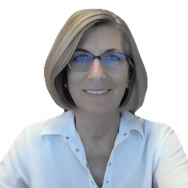 A woman with short blonde hair and glasses smiles warmly while wearing a white shirt. She appears friendly and approachable, suitable for professional contexts.