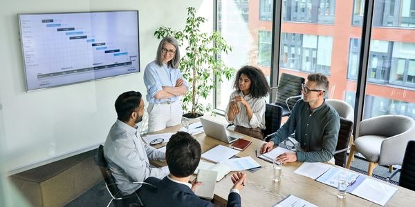 Leadership discussion in modern office focused on improving company culture and team alignment.