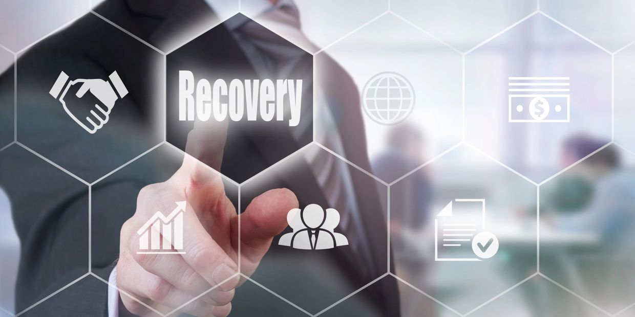 A businessman selecting a Recovery Concept button on a clear screen.