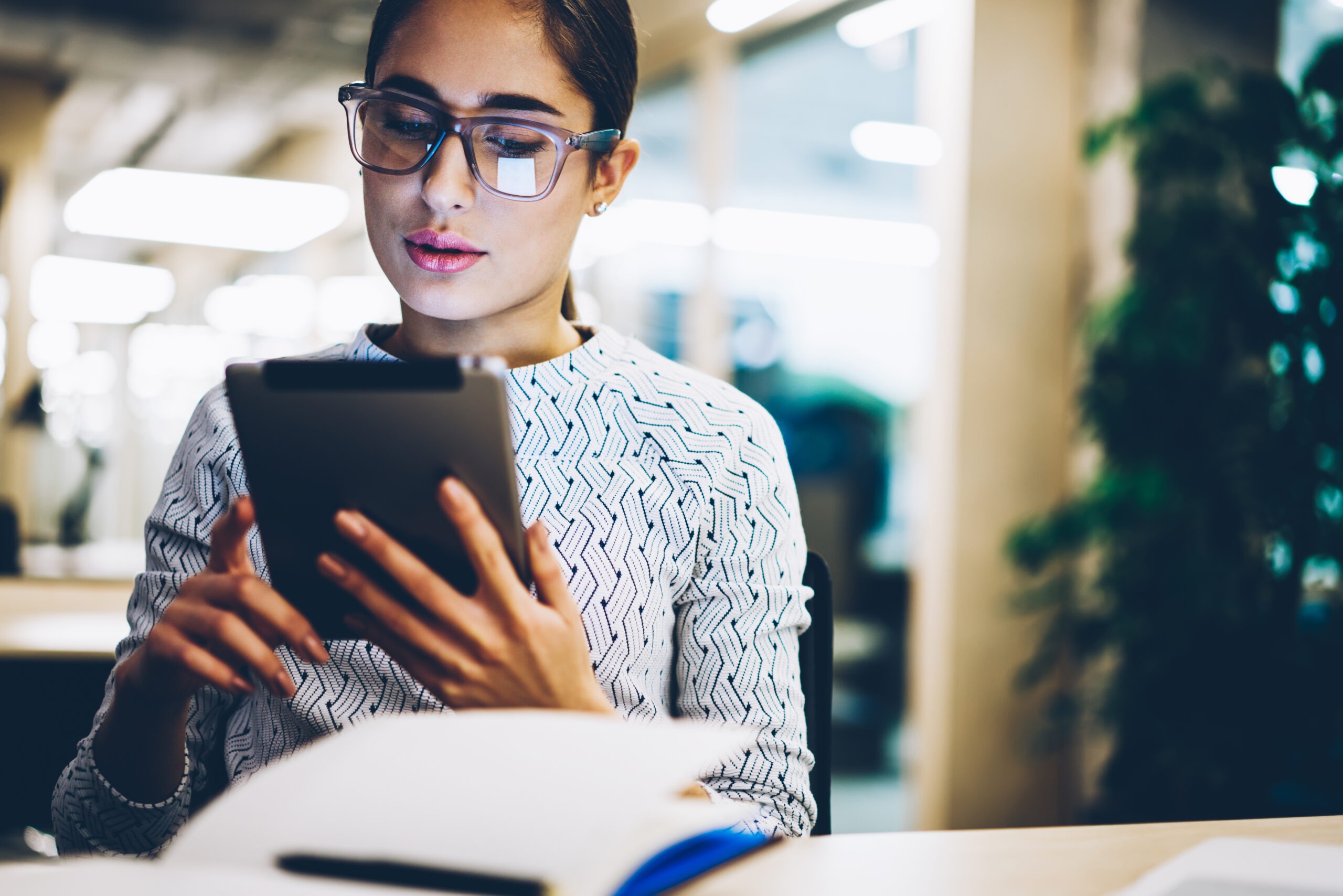 Pensive young businesswoman reading information doing money transaction via tablet banking application, female student watching tutorial on touchpad online doing homework task in coworking space; Shutterstock ID 1051137050; Purchase Order: comps; Job: ; Client/Licensee: ; Other:
