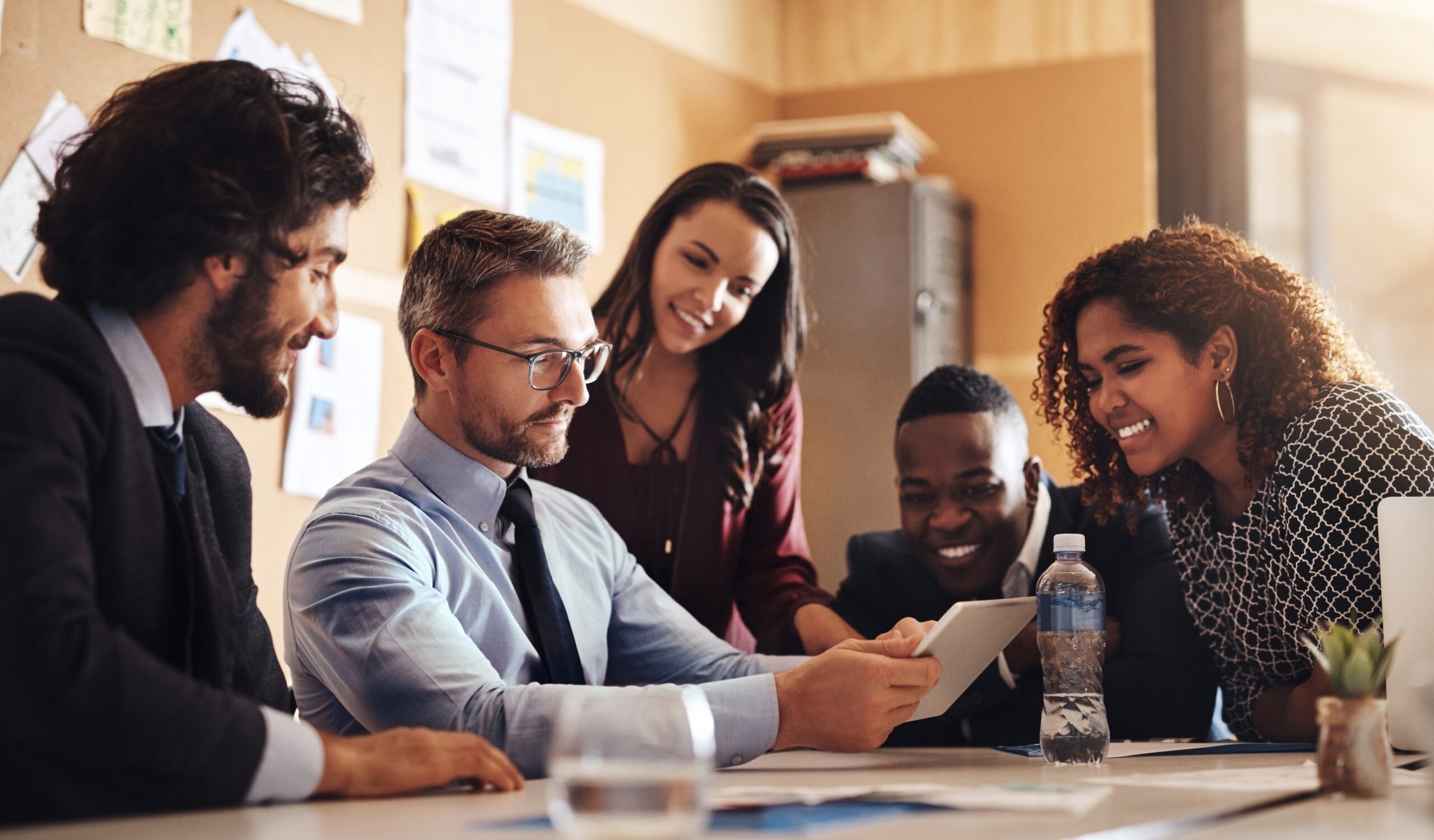 Business, meeting and male leader with tablet for innovation, new software or company development in office. Smile, diversity or man with tech for strategy, brainstorming or corporate success in team; Shutterstock ID 2490418599; purchase_order: Pro Serv; job: ; client: ; other: