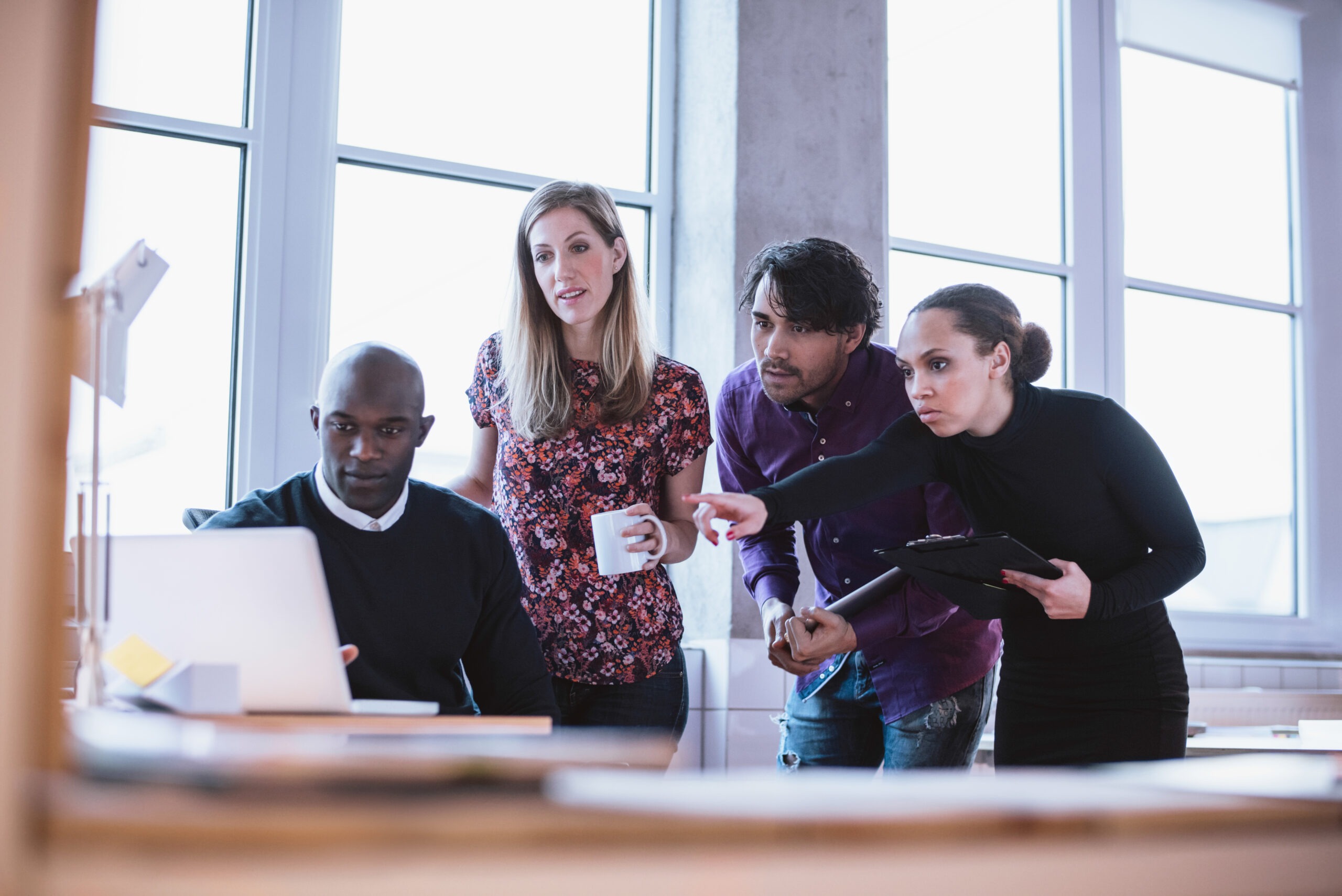 Portrait of a modern business team working at new project during meeting and looking at laptop. Multiracial business people working together.; Shutterstock ID 253053913; purchase_order: Limited 7/26/21